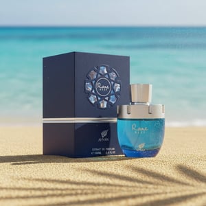 Perfume bottle on Langkawi or Penang beach sand, tropical breeze effect, warm sunlight + cool blue tones, premium men lifestyle vibe.