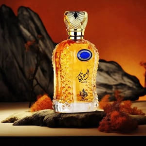 Decorative bottle with intricate design and gold accents on a textured surface with a desert landscape background.