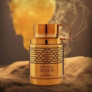 Gold Odyssey Aoud perfume bottle with smoke effect on a textured surface