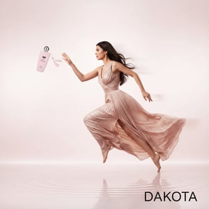 Pink 'Dakota' perfume bottle and packaging with price and contact information on a white background