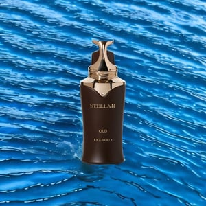 Stellar Oud perfume bottle on a blue water background