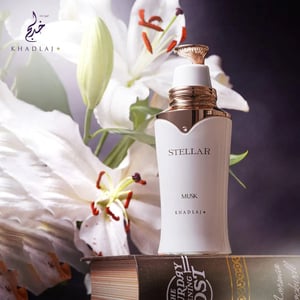 Stellar Musk perfume bottle by Khadlaj with white lilies in the background