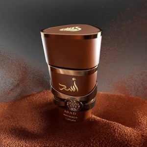 Brown container with gold accents on a textured brown surface