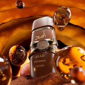 ASAD Bourbon bottle surrounded by amber liquid and chocolate shavings
