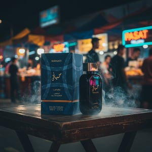 Hayaati Al Maleky at a Malaysian night market table with neon ripples and faint oud smoke; bottle and box clearly visible.