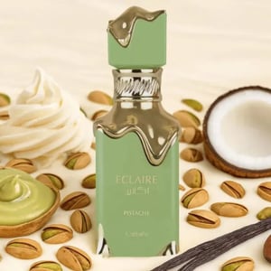 Green perfume bottle with pistachio, coconut, and vanilla beans on a beige background