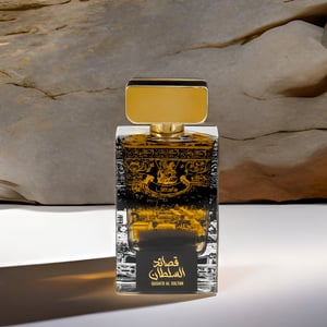 Lattafa Perfume Malaysiabottle with gold cap and detailed label against a stone wall background