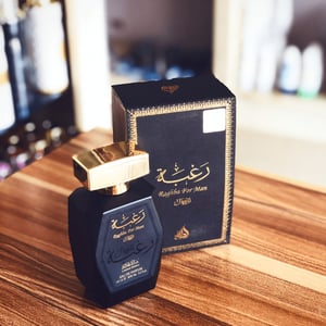 Perfume bottle and packaging on a wooden surface lattafa perfumes malaysia