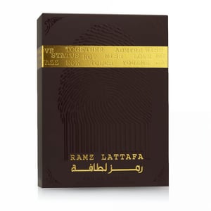 Dark brown packaging with gold text featuring the brand 'Ramz Lattafa' on a white background