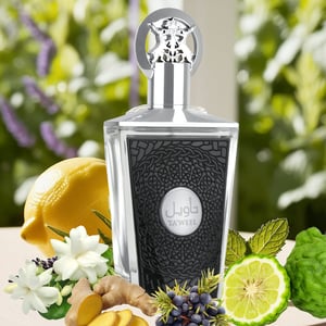 taweel lattafa Perfume bottle with decorative elements like lemons, flowers, and herbs on a blurred natural background
