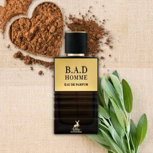 B.A.D Homme eau de parfum bottle with cocoa powder and leaves on a textured background