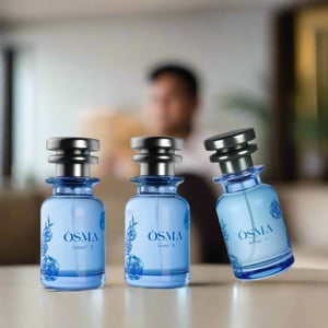 Three blue perfume bottles with silver caps on a reflective surface against a light blue background.