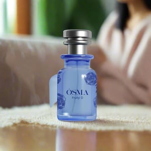 Blue perfume bottle with silver cap on a white background