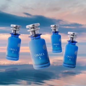 Four blue perfume bottles labeled 'OSMA' against a scenic background with water and sky.