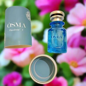 Blue Osma bottle and cylindrical container on a floral-patterned background