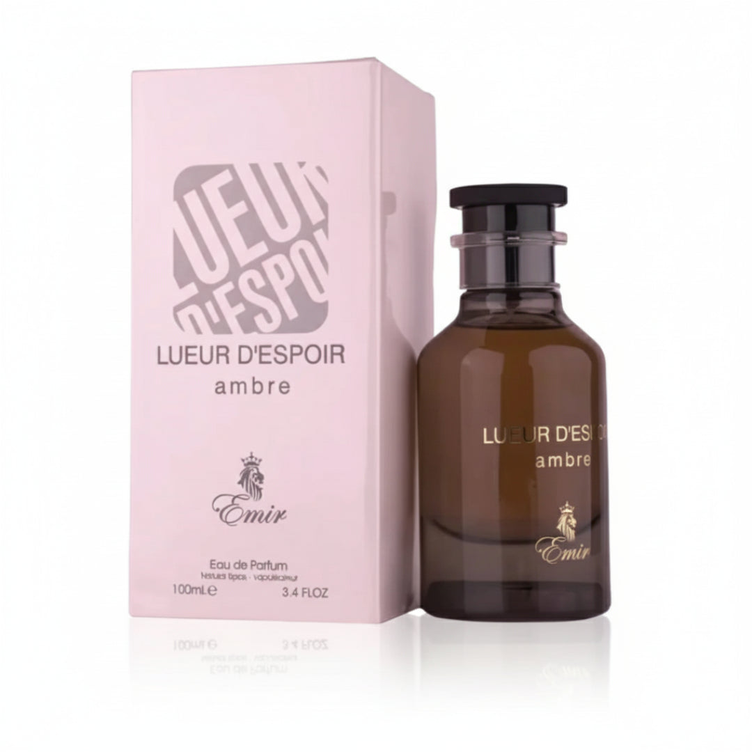 Brown perfume bottle and pink packaging with 'Lueur d'Espoir' branding on a white background