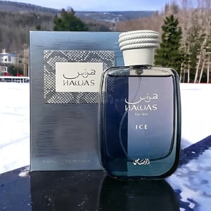Hawas perfume bottle and packaging on a snowy surface with trees in the background