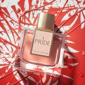 Perfume bottle labeled 'Pride Pour Femme' on a red and white abstract background