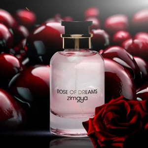 Perfume bottle labeled 'Rose of Dreams zimaya' surrounded by red roses and berries on a dark background